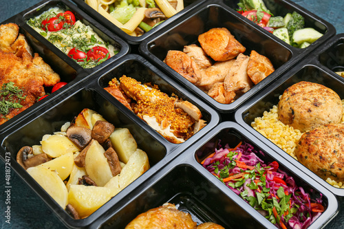 Food delivery containers with different delicious meals, closeup
