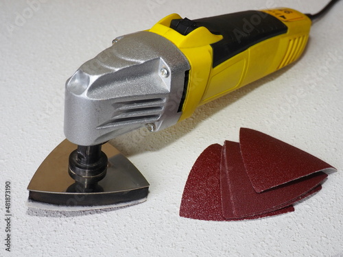 Heavy duty oscillating multitool with sanding pad. Sand paper for oscillating multitool. Grinding and polishing tool 