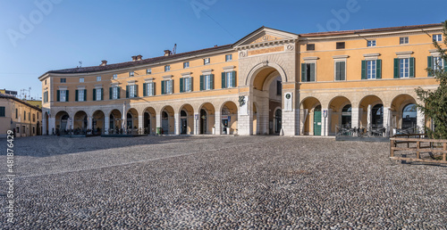 Classical arcade on cobbled square in historical town, Rovato, Italy