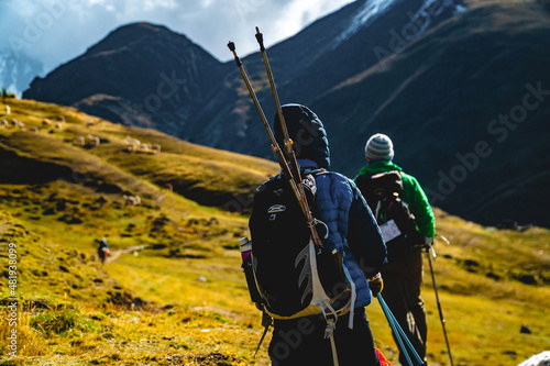 Adventure seekers hiking in the mountains with their trekking polls