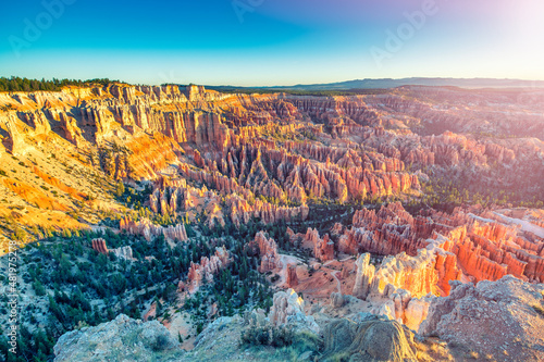 Aerial view of Bryce Canyon at summer sunrise. Overlook of orange colorful hoodoos red rock formations in Bryce Canyon National Park, Utah - USA.