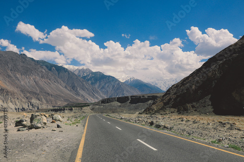 Asphalt Road in the High Gilgit Baltistan Mountains under the Blue Clouds, Pakistan