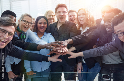 Business team stacking their hands together