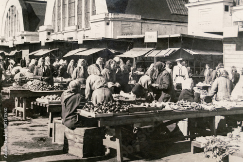 Latvia - CIRCA 1940s: Vintage archive photo of Riga Central Market. People trading all kinds of vegetable on a street market