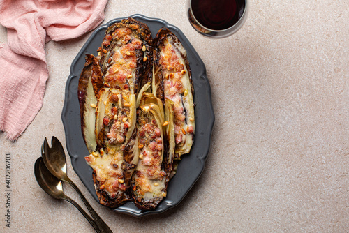 Baked red Radicchio with Bacon, bechamel, pine nuts and parmesan cheese. Red wine. Italian food. Copy space.