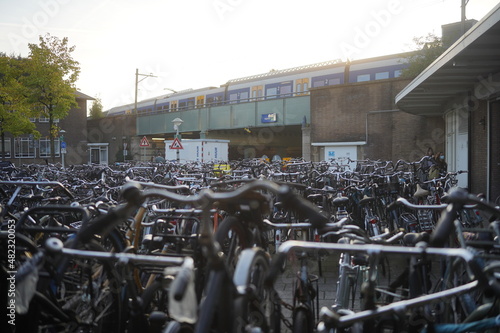 many bicycles at a train station in amsterdam