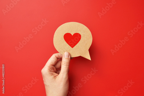 Red paper heart on a conversational cloud. Symbol of love and conversation and declaration of love 
