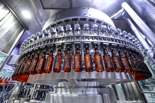 Filling plastic bottles with various drinks on an automatic filling machine