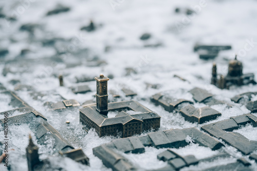 Lviv, Ukraine - January 19, 2022 : Lviv City Hall bronze miniature model with snow. Lviv tourist attraction for winter season