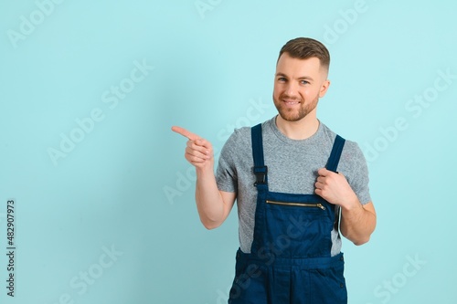 Close-up portrait of his he nice attractive cheerful cheery content guy repairer craftsman isolated over blue color background.