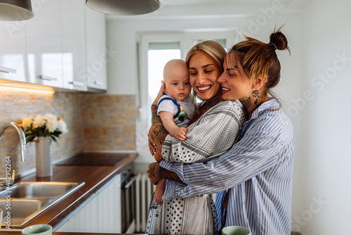 Two lesbian women with a baby boy at home