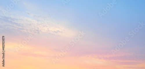 Clear blue sky. Pink and golden glowing clouds. Sunrise. Dramatic cloudscape. Concept art, meteorology, heaven, hope, peace, graphic resources, picturesque panoramic scenery