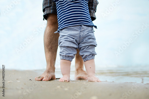 Father and son walking by the ocean