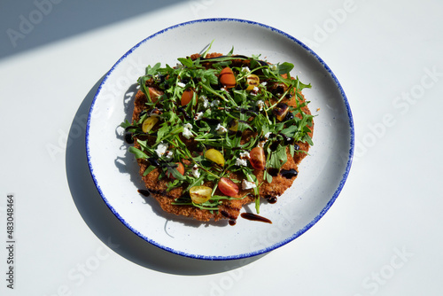 Chicken Milanese served in a round plate on 