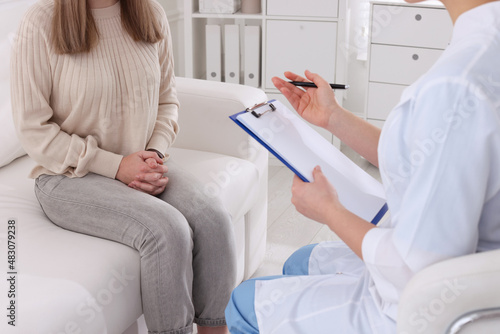 Young woman having appointment with STD specialist in clinic, closeup