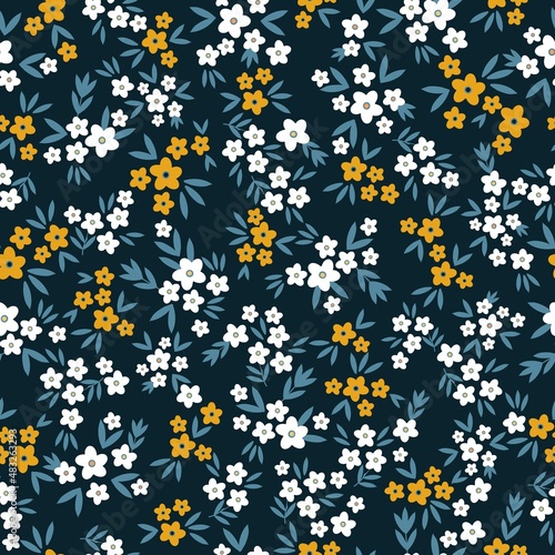 Seamless vintage pattern. Small white and orange flowers, green leaves. Dark blue background. vector texture. fashionable print for textiles, wallpaper and packaging.