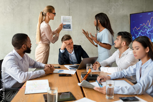 Business Conflicts. Two Female Employees Arguing During Corporate Meeting In Office