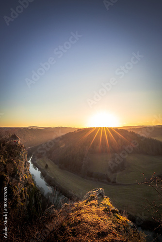 The Moselle Loop in Rhineland-Palatinate, Germany. Beautiful landscape shot at sunrise with fog in the morning over the town of Brem in the wine field of a steep slope