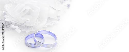 Wedding rings on wedding card on a white background, border design panoramic banner. Trendy Image, Toned in Color of the year 2022, Very Peri. 