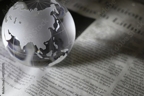 ガラスの地球儀と新聞 グローバルな事象のイメージ glass globe(Asia and Oceania) on newspapers