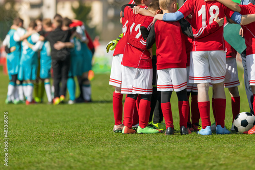 Two Football Teams Standing in Team Circles Before Tournament Final Match. School Soccer Players in Red and Blue Soccer Jersey Uniforms. Sports Kids on Briefing With Coach