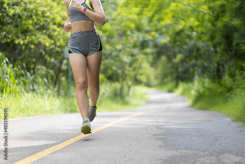 Young woman jogging to exercise and relax in the park.