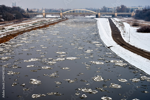 Floe on the Warta River and a road bridge during winter in the city