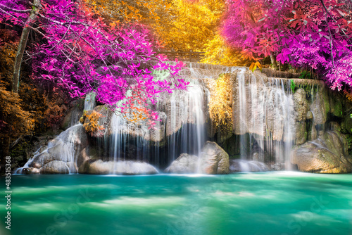 Amazing in nature, beautiful waterfall at colorful autumn forest in fall season. 