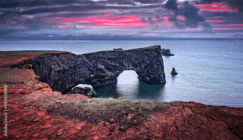 Majestic large arch of lava on the coast in Atlantic Ocean during sunset. Amazing Icelandic scenery. one most Popular Travel destinations in Iceland. Sudurland, cape Dyrholaey, Iceland, Vik, Europe