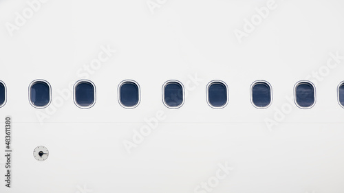 Windows on fuselage of airplane. White plane with copy space.