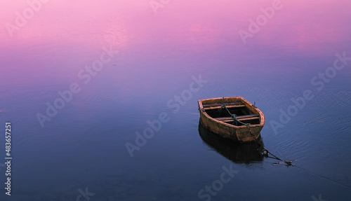 minimalist photo of a docked fishing boat, waiting for the tide to rise. San Vicente de la Barquera. Cantabria, Spain.