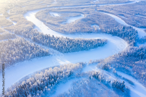 Winter landscape. Aerial view. Landscape with winding river and snowy forest in Western Siberia. Agan River, Yugra