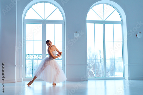 ballerina in white tutu and leotard on pointe shoes