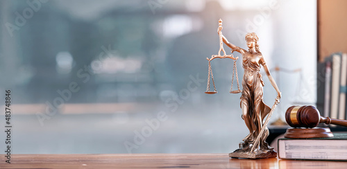 Legal and law concept. Statue of Lady Justice with scales of justice and wooden judge gavel on wooden table. Panoramic image statue of lady justice.