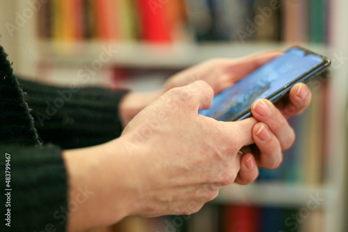 A woman holding a cell phone in her hands