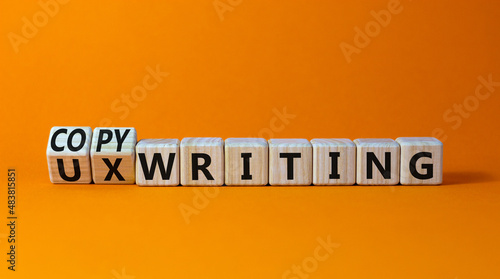 Copywriting or UX writing symbol. Turned cubes and changed concept words copywriting to UX writing. Beautiful orange background copy space. Business copywriting or UX writing user experience concept.