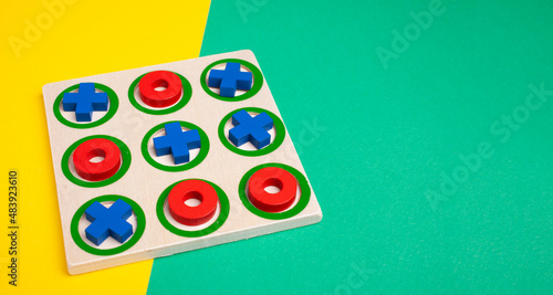 tic-tac-toe board game concept on yellow and green background with copy space