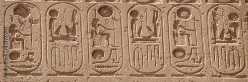 Relief details and Egyptian hieroglyphs at Karnak temple complex in Luxor