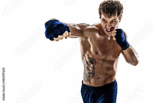 Portrait of aggressive boxer who training and practicing swing on white background. Blue sportswear