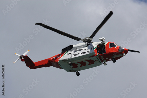 coast guard rescue helicopter in flight with door open