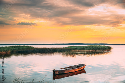 Braslaw Or Braslau, Vitebsk Voblast, Belarus. Wooden Rowing Fishing Boat In Beautiful Summer Sunset On The Dryvyaty Lake. This Is The Largest Lake Of Braslav Lakes. Typical Nature Of Belarus.Braslaw