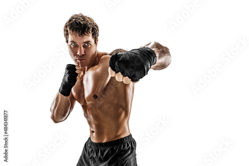 Studio shot of aggressive boxer who training and practicing swing on white background. Sport concept