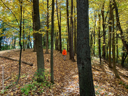 Hiker in blaze orange safely hiking the Ice Age Trail