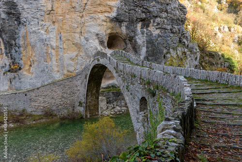 Kokori's old arch stone bridge (Noutsos) during fall season situated on the river of Voidomatis in Zagori, Epirus Greece.