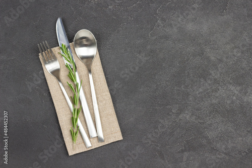 Set of cutlery on linen napkin.