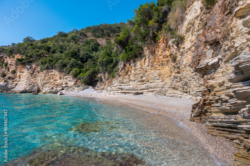 Secret beach with crystal clear turquoise water and cliffs near Syvota reached by boat - Syvota, Plataria, Epirus, Greece