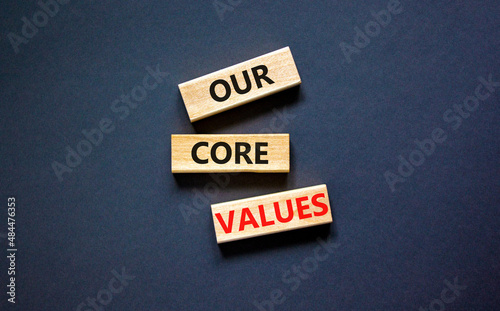 Our core values symbol. Concept words Our core values on wooden blocks on a beautiful black table black background. Business value and our core values concept. Copy space.
