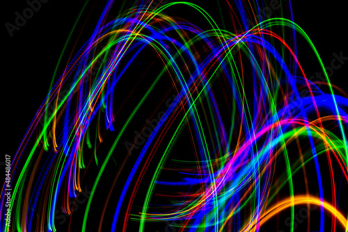 Colorful elliptic thin stripes on a black background.