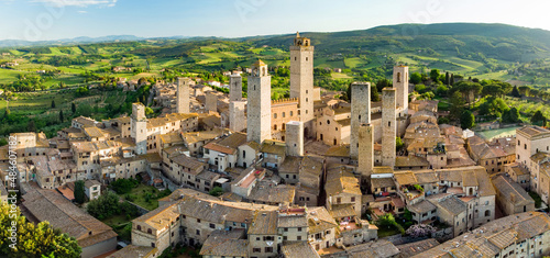 Aerial view of famous medieval San Gimignano hill town with its skyline of medieval towers, including the stone Torre Grossa. UNESCO World Heritage Site.