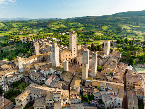 Aerial view of famous medieval San Gimignano hill town with its skyline of medieval towers, including the stone Torre Grossa. UNESCO World Heritage Site.